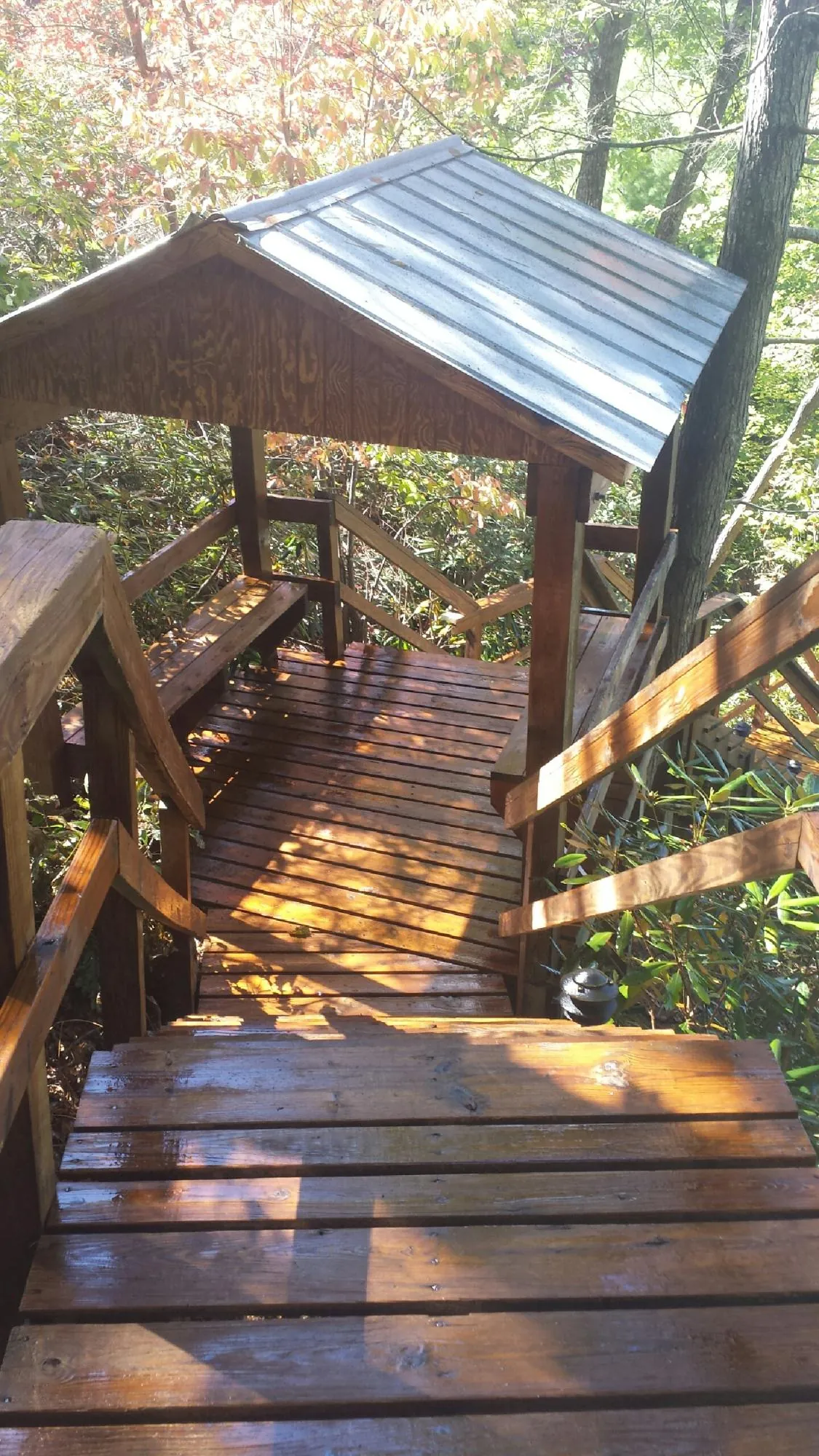 Freshly stained wood walkway and covered shelter with a metal roof in Royalton