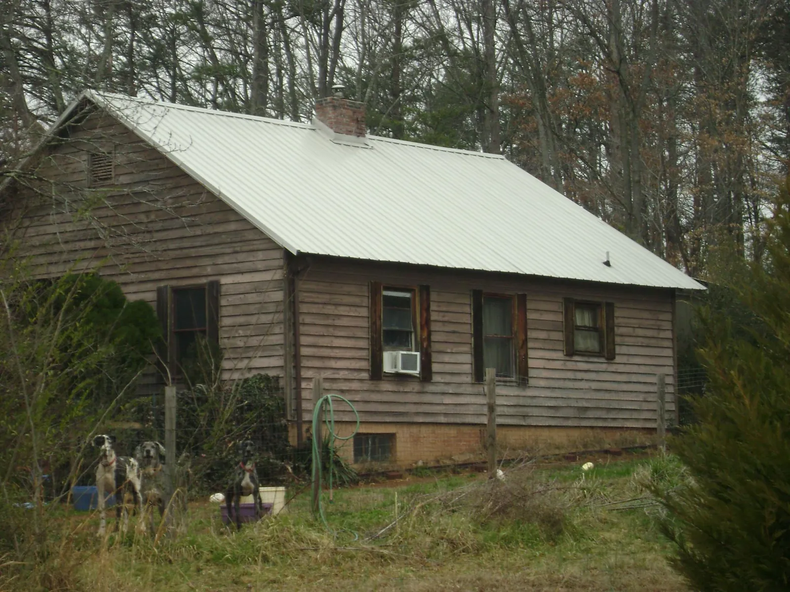 White metal roof on an old wood sided farmhouse, from a Metal Roof Installation job in Royalton